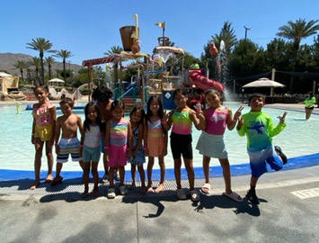 Kingston children together during a past summer water-play outing