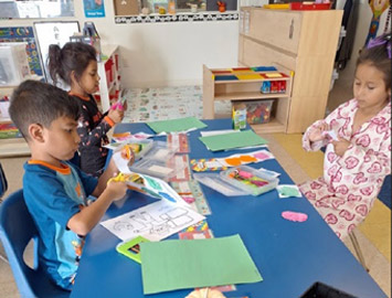 Kingston children using art materials around a classroom table