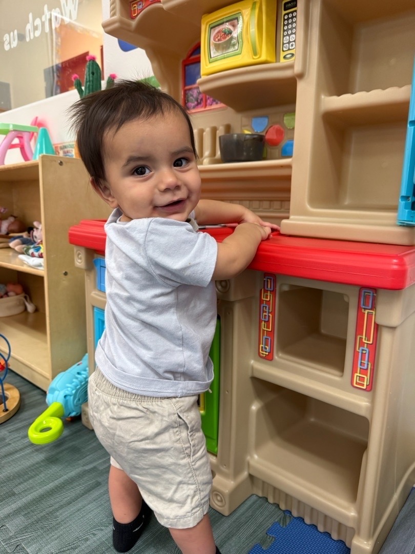 Exploring the play kitchen at Kingston Academy