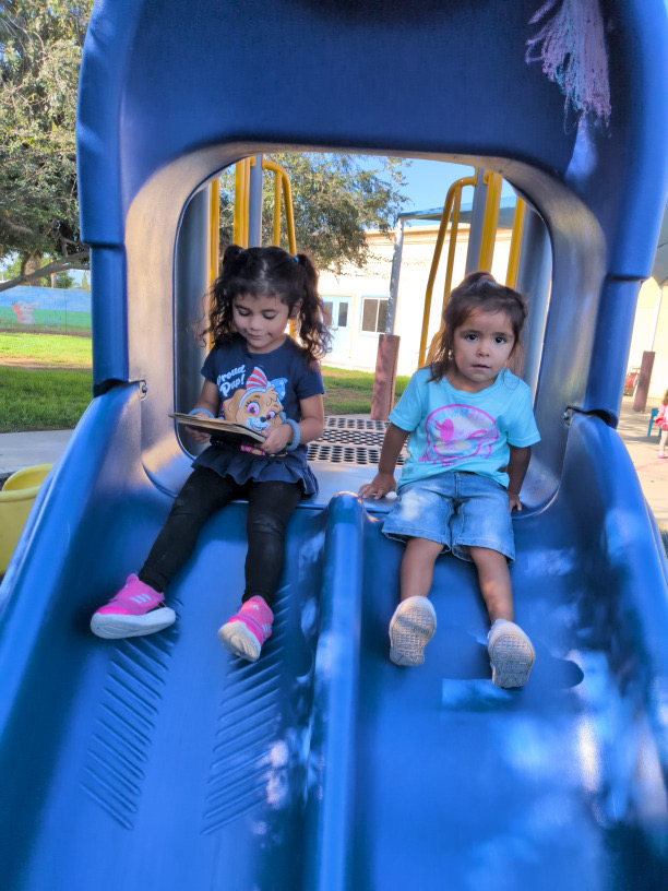 Side-by-side slide smiles at Kingston Academy