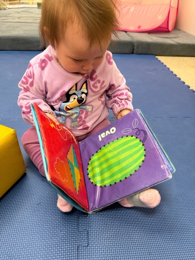 A child exploring a colorful picture book